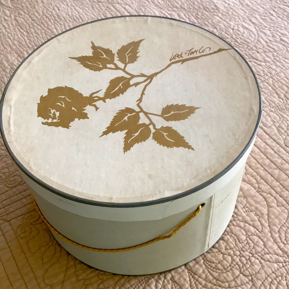 Vintage Lord and Taylor cardboard hat box with gold cord handle.